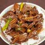 Ginger Beef on a plate of white rice.